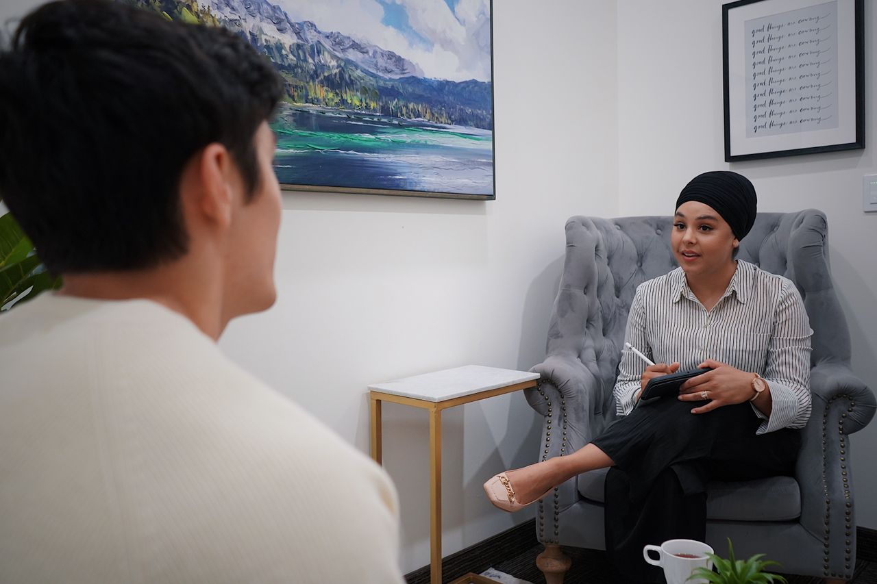 About A therapist conducts a one-on-one session with a client in a comfortable office environment.